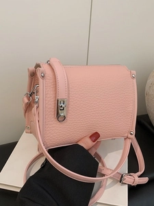 Pink faux leather shoulder bag with lychee texture and metallic twist lock closure