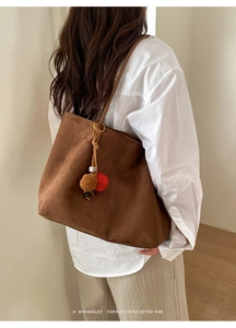 Minimalist dark brown suede tote bag with retro charm hanging beads on a slim strap