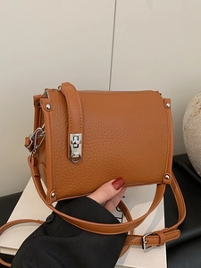Vintage brown pebbled leather shoulder bag with silver buckle and adjustable strap