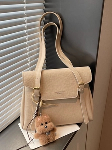 Chic beige tote bag in lychee pattern leather with a cute plush dog charm