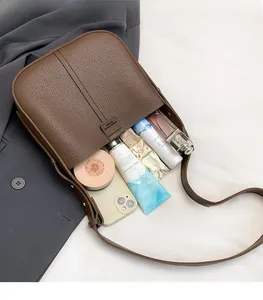Detail of dark brown lychee leather bag interior showing high storage capacity