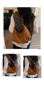 Detailed view of brown faux suede tote bag featuring wide pleated straps and crescent design