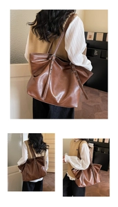 Detail der dunkelbraunen Leder-Shopper mit Vintage-Textur und Ösen am Schultergurt
