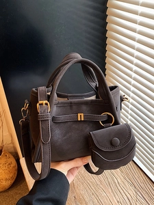Minimalist bucket bag in charcoal grey suede with adjustable strap and small coin purse