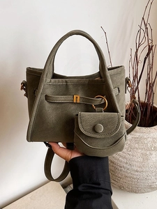 Minimalist dark green bucket bag with matching round pouch and antique brass hardware