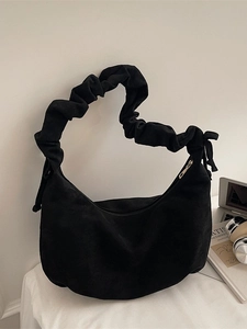 Minimalist black faux suede moon bag with aesthetic ruched strap and metal zipper detail