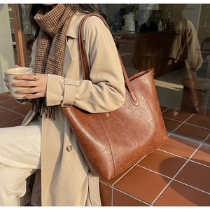 Detailed view of large brown vintage leather tote bag with fine stitching details