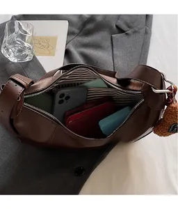 Interior view of brown faux leather crescent bag showing ample storage capacity