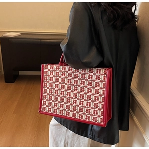 Detail of red bridal tote bag featuring traditional double happiness pattern and leather trim