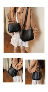 Detail view of black lychee grain leather bucket bag set with adjustable shoulder strap