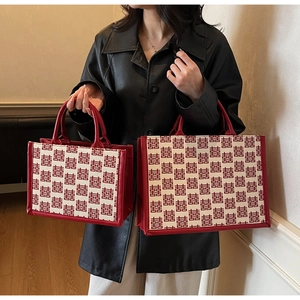 Detail of red and beige wedding tote bag set featuring traditional double happiness patterns