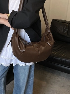 Classic dark brown croissant bag with pleated design and wide shoulder strap