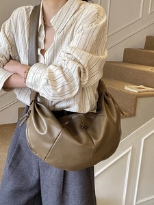 Olive brown crescent crossbody bag in soft PU leather with decorative knot shoulder strap