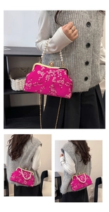 Close-up of rose red satin bag featuring floral embroidery and elegant pearl handle