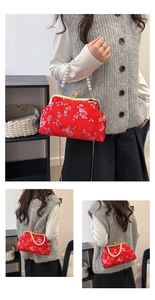 Detail of red brocade purse with pearl handle and embroidered plum blossom patterns