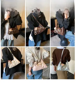 Multiple color options for retro underarm bags with plush bear pendants on models