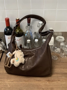 Retro deep brown half-moon hobo bag with adjustable strap and alpaca plush charm