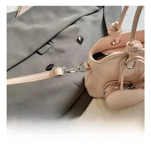 Polished silver metal hook detail and heart charm on a pink leather handbag