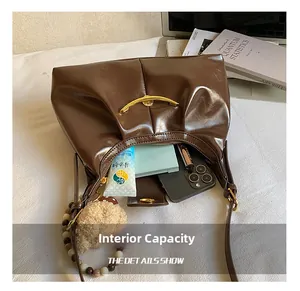 Interior view showing the large capacity for phone, lipstick and cosmetics in a shoulder bag