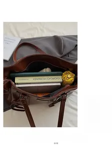 Interior view of large brown patent leather tote showing spacious storage for books and tablet