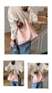 Detail of pink leather tote bag featuring a cute brown bear charm and stitching