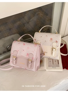 Detail of cute cat and cupcake prints on pink and white PU leather handbags