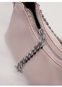 Detail of pink vintage chain bag showing the silver zipper and metal texture