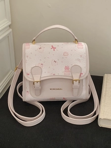 Pink cartoon cat patterned leather handbag with golden hardware and cupcake print