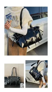 Vintage waxed leather tote bag shown on model featuring drawstring closure and tassel details