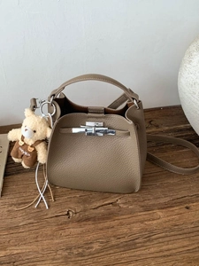 Litchi pattern bucket bag in taupe with silver twist lock and cute teddy bear pendant