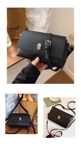 Detail of a black retro crossbody bag showing the leather texture and silver oval twist lock