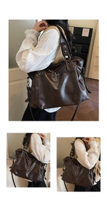 Detail of retro large tote bag in dark brown PU leather with gothic cross pendant