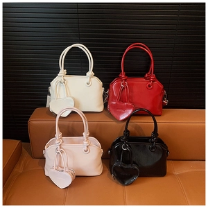 Selection of chic handbags in white, red, pink, and black with heart charms