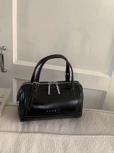 Modern black glossy Boston handbag with silver hardware and MUNETI metal logo charm