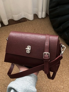 Minimalist wine red crossbody bag with silver rotating lock and leather texture
