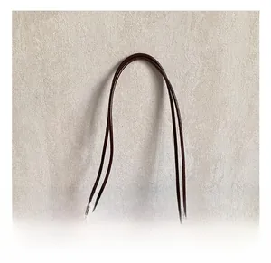 Detail of glossy dark brown crescent bag with smooth metallic zipper and fine handles
