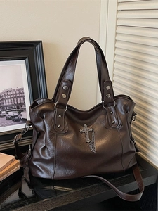 Deep brown large tote bag with gothic metal cross and chain in vintage setting