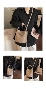 Detail of lychee pattern leather bucket bag set with metal buckle and detachable strap