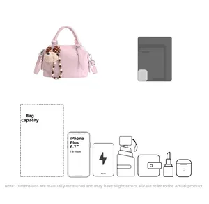 Detail view of the pink Boston bag storage capacity for phone, umbrella and cosmetics