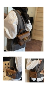 Detail showing vintage brown square bag with gold oval lock and mixed texture material