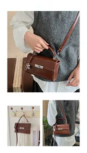 Detail of a brown leather crossbody bag with silver twist lock and woven charm decoration
