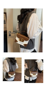 Detail of color-block mini handbag featuring brown flap and gold metal twist-lock buckle