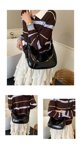 Three views showing a black glossy crescent shoulder bag worn on the body from different angles