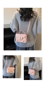 Pink retro crossbody box bag featuring gold hardware lock and delicate textured finish