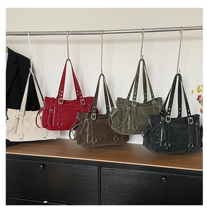 Detail view of large retro tote bags in cream, red, brown, green and black colors