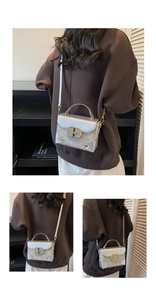 Detail of silver mini crossbody bag with gold hardware and removable shoulder strap