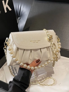 Creamy white ruched cloud bag with pearl and chain straps for shoulder or crossbody wear