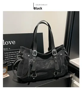 Detail of black punk tote bag with matte leather texture and silver metal buckles