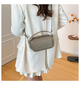 Detailed view of silver sequin rectangular crossbody bag with chain strap and top handle