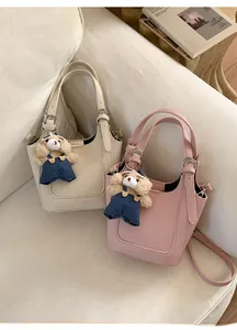 Litchi pattern leather bucket bags in cream and pink with cute teddy bear pendants